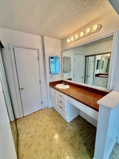 5269 Vineland Rd Unit 101, Orlando, FL 32811 - bathroom with vanity and a textured ceiling