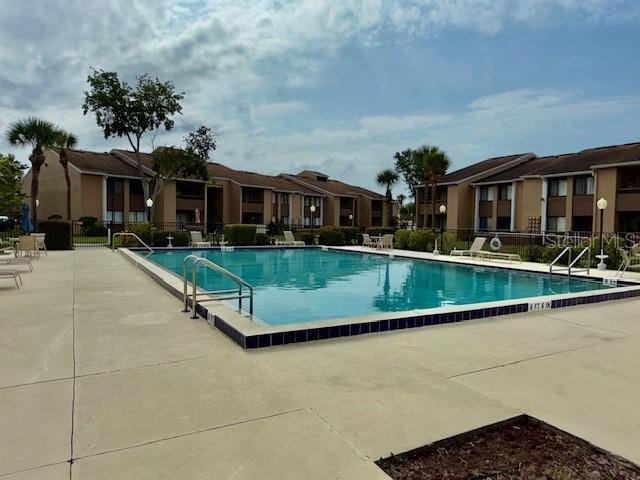 5269 Vineland Rd Unit 101, Orlando, FL 32811 - community pool with a patio area and a residential view