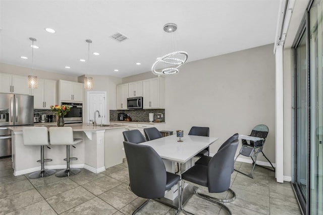 1821 Benevento St, Saint Cloud, FL 34771 - dining area featuring recessed lighting, light tile patterned floors, baseboards, and a chandelier