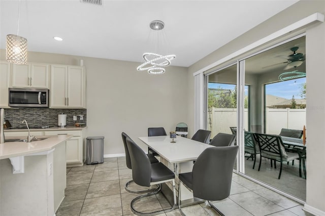1821 Benevento St, Saint Cloud, FL 34771 - dining space featuring light tile patterned floors, recessed lighting, baseboards, and a chandelier