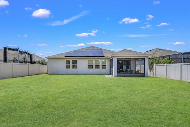 1821 Benevento St, Saint Cloud, FL 34771 - rear view of house featuring roof mounted solar panels, stucco siding, a sunroom, and a shingled roof