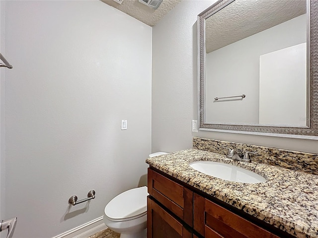 7679 Bent Bow Trl, Winter Park, FL 32792 - half bath with vanity, a textured ceiling, toilet, and baseboards