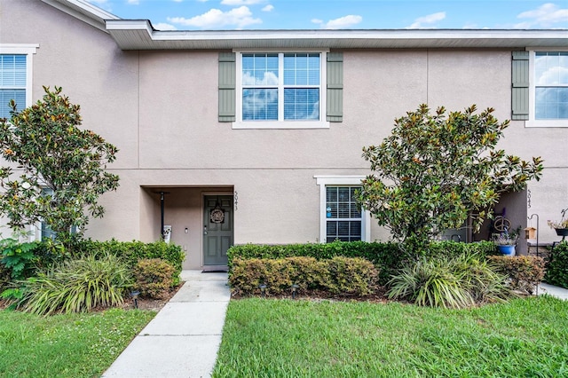 5043 Cactus Needle Ln, Wesley Chapel, FL 33544 - view of property with stucco siding and a front lawn