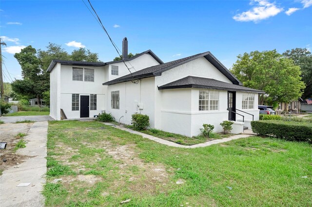 161 Bolender Rd, Auburndale, FL 33823 - view of side of property featuring stucco siding and a lawn