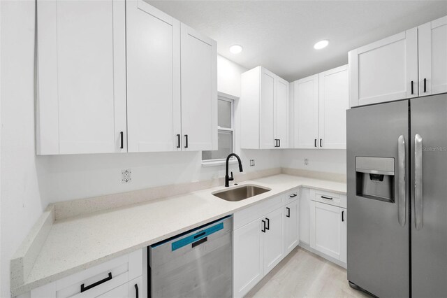 161 Bolender Rd, Auburndale, FL 33823 - kitchen featuring appliances with stainless steel finishes, a sink, white cabinetry, and recessed lighting