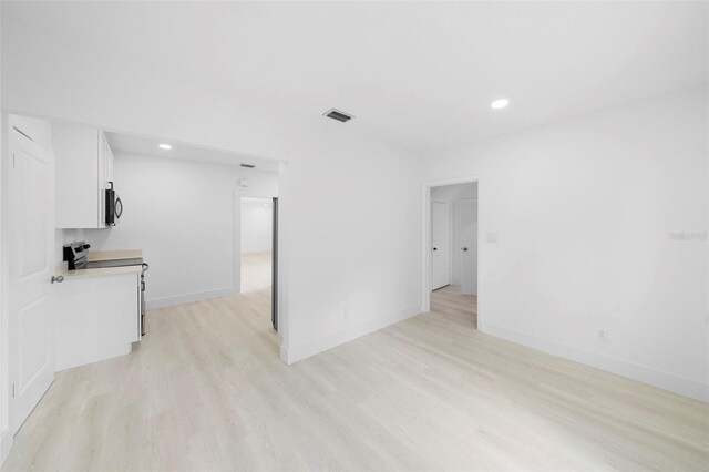 161 Bolender Rd, Auburndale, FL 33823 - unfurnished living room with light wood finished floors, recessed lighting, and baseboards