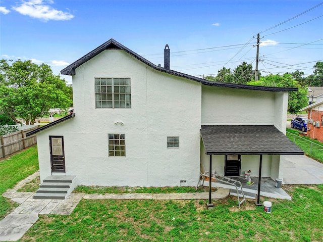 161 Bolender Rd, Auburndale, FL 33823 - back of property with stucco siding, roof with shingles, and a chimney