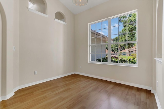 3014 Linmont Ln, Eustis, FL 32726 - unfurnished room with light wood finished floors, baseboards, and a chandelier