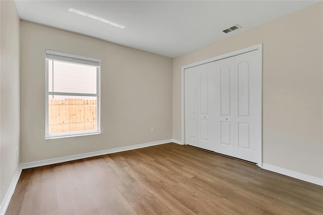 3014 Linmont Ln, Eustis, FL 32726 - unfurnished bedroom featuring wood finished floors, baseboards, and a closet