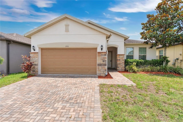 3953 Baja Dr, Saint Cloud, FL 34772 - view of front of home with stone siding, stucco siding, decorative driveway, and an attached garage