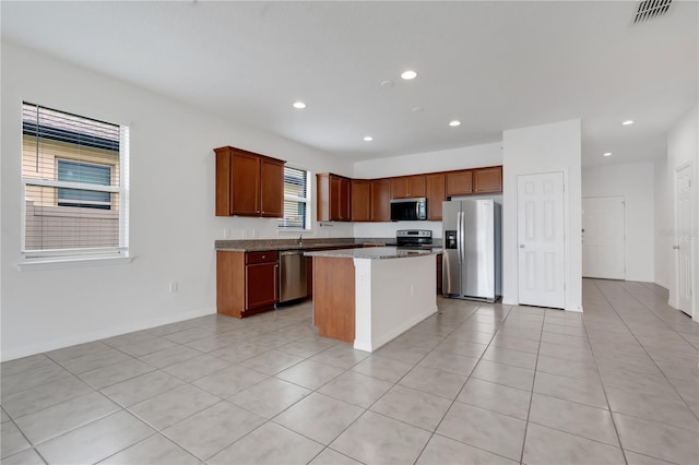 3953 Baja Dr, Saint Cloud, FL 34772 - kitchen featuring stainless steel appliances, recessed lighting, a kitchen island, light tile patterned flooring, and a sink