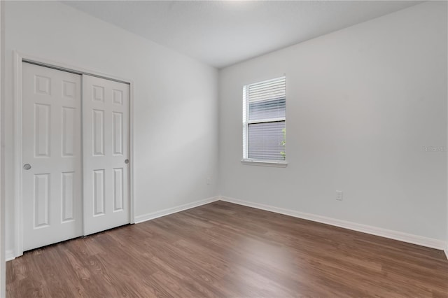 3953 Baja Dr, Saint Cloud, FL 34772 - unfurnished bedroom with wood finished floors, baseboards, and a closet
