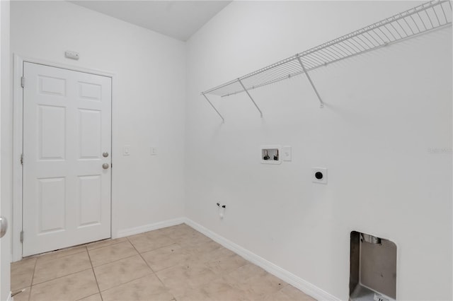 3953 Baja Dr, Saint Cloud, FL 34772 - washroom with washer hookup, electric dryer hookup, baseboards, and light tile patterned floors