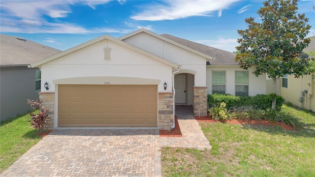 3953 Baja Dr, Saint Cloud, FL 34772 - view of front of property featuring stone siding, stucco siding, a garage, decorative driveway, and a shingled roof