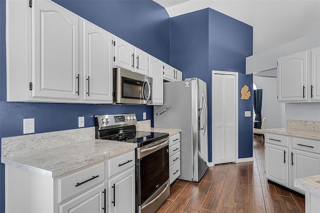 2203 Essex Dr, Ocoee, FL 34761 - kitchen featuring appliances with stainless steel finishes, baseboards, white cabinetry, dark wood finished floors, and light countertops