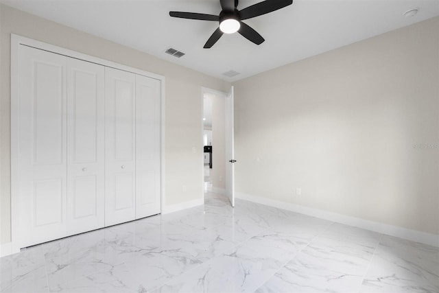 13619 SW 78th Pl, Dunnellon, FL 34432 - unfurnished bedroom with light marble finish floors, a closet, and ceiling fan