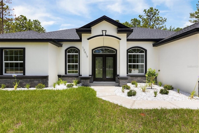13619 SW 78th Pl, Dunnellon, FL 34432 - entrance to property with french doors, a shingled roof, and stucco siding