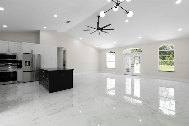 13619 SW 78th Pl, Dunnellon, FL 34432 - unfurnished living room with healthy amount of natural light, arched walkways, light marble finish floors, ceiling fan, and recessed lighting