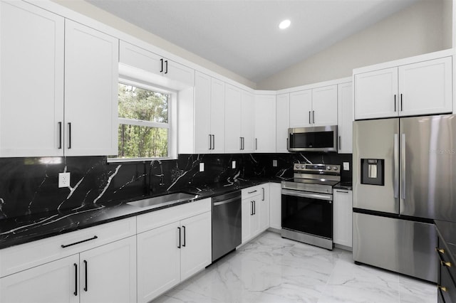 13619 SW 78th Pl, Dunnellon, FL 34432 - kitchen with stainless steel appliances, backsplash, lofted ceiling, white cabinets, and light marble finish flooring