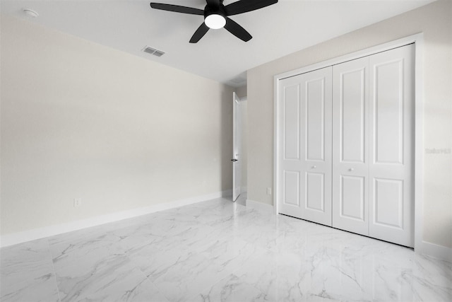 13619 SW 78th Pl, Dunnellon, FL 34432 - unfurnished bedroom featuring marble look tile flooring, a closet, and ceiling fan