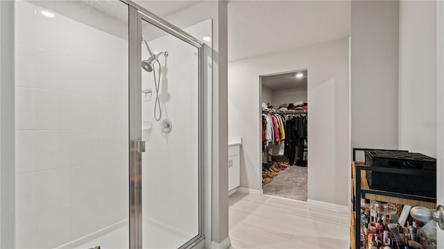 5291 Meredrew Ln, Saint Cloud, FL 34771 - full bathroom with a spacious closet, a shower stall, baseboards, and recessed lighting
