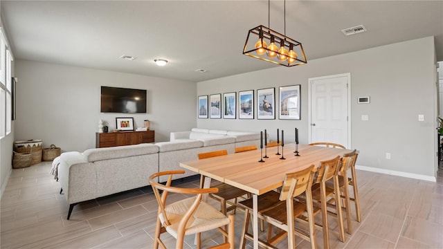5291 Meredrew Ln, Saint Cloud, FL 34771 - dining room with a chandelier and baseboards