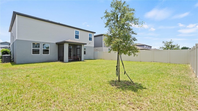 5291 Meredrew Ln, Saint Cloud, FL 34771 - rear view of house with a sunroom, stucco siding, and cooling unit
