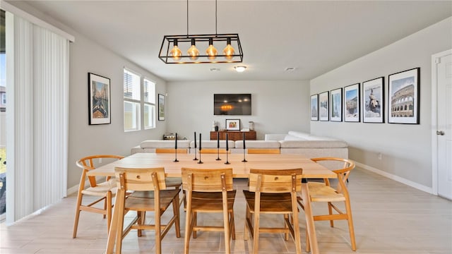 5291 Meredrew Ln, Saint Cloud, FL 34771 - dining space with baseboards, light wood-style floors, and a chandelier