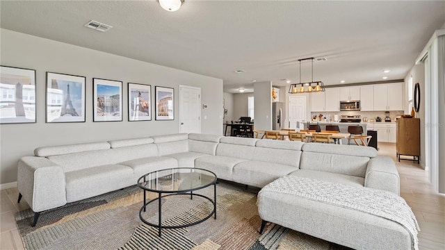 5291 Meredrew Ln, Saint Cloud, FL 34771 - living room featuring light wood-style floors, a chandelier, baseboards, and recessed lighting