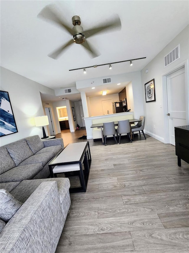 14501 Grove Resort Ave Unit 3737, Winter Garden, FL 34787 - living room featuring track lighting, light wood-style floors, a ceiling fan, and baseboards