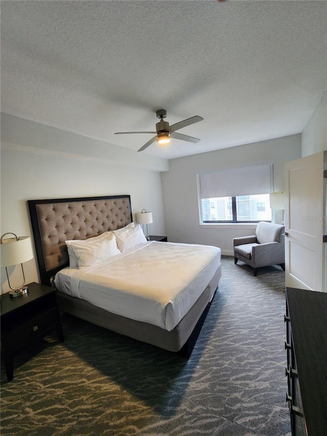 14501 Grove Resort Ave Unit 3737, Winter Garden, FL 34787 - bedroom with dark colored carpet, a textured ceiling, and ceiling fan