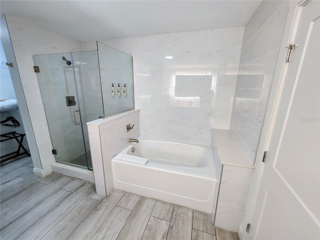 14501 Grove Resort Ave Unit 3737, Winter Garden, FL 34787 - bathroom featuring wood finish floors, a bath, and a shower stall