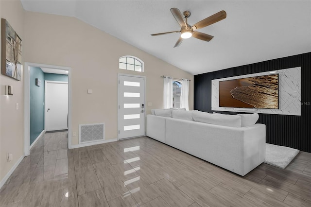 5729 Norman H Cutson Dr, Orlando, FL 32821 - living area featuring an accent wall, lofted ceiling, ceiling fan, baseboards, and wood finished floors