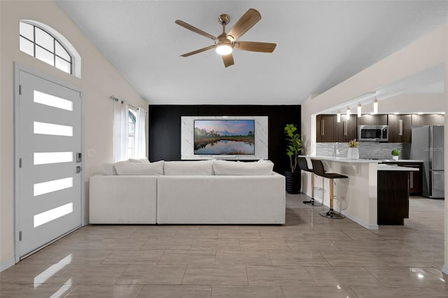 5729 Norman H Cutson Dr, Orlando, FL 32821 - living room with vaulted ceiling, an accent wall, and a ceiling fan