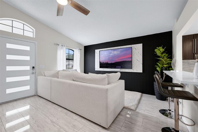 5729 Norman H Cutson Dr, Orlando, FL 32821 - living room with an accent wall, vaulted ceiling, and ceiling fan