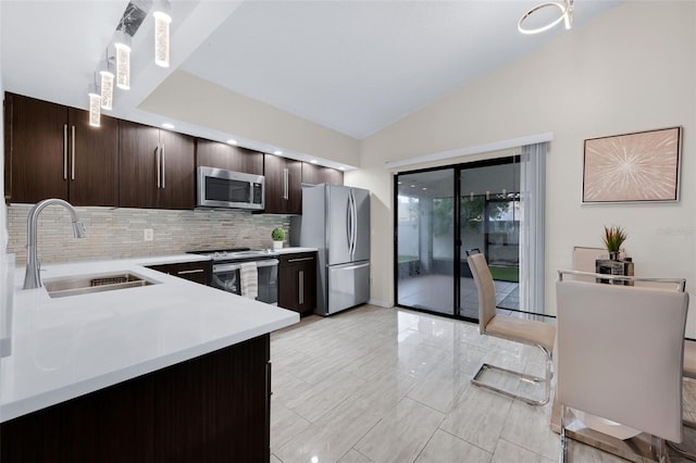 5729 Norman H Cutson Dr, Orlando, FL 32821 - kitchen featuring appliances with stainless steel finishes, a sink, dark brown cabinets, light countertops, and tasteful backsplash