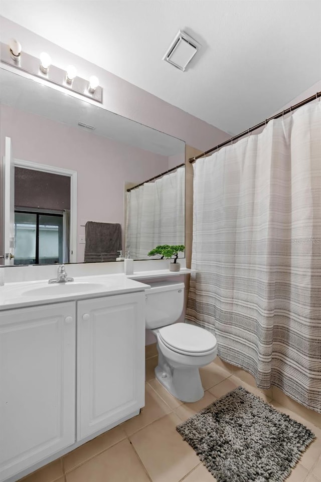 5729 Norman H Cutson Dr, Orlando, FL 32821 - bathroom featuring toilet, tile patterned flooring, and vanity