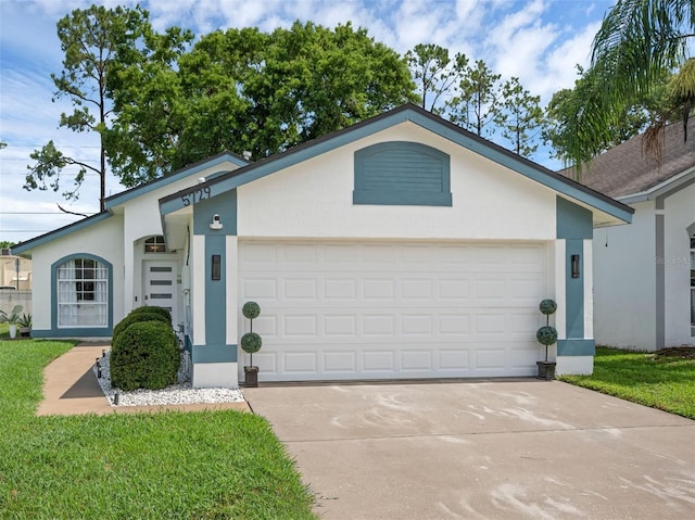 5729 Norman H Cutson Dr, Orlando, FL 32821 - view of front of house with a garage, stucco siding, and concrete driveway