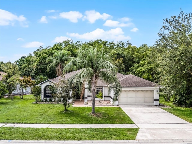 2888 Middleton Cir, Kissimmee, FL 34743 - view of front of house with an attached garage, a front yard, stucco siding, concrete driveway, and roof with shingles