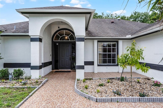 2888 Middleton Cir, Kissimmee, FL 34743 - doorway to property with a shingled roof and stucco siding