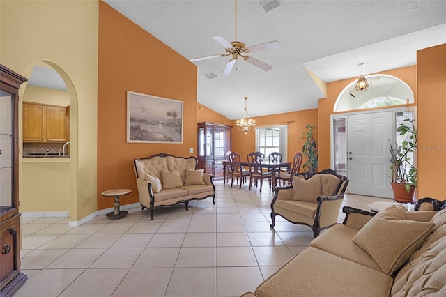 2888 Middleton Cir, Kissimmee, FL 34743 - living room featuring a chandelier, light tile patterned floors, a ceiling fan, arched walkways, and high vaulted ceiling