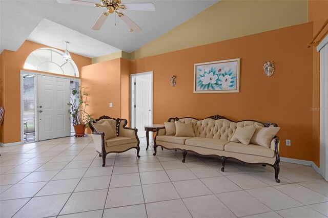 2888 Middleton Cir, Kissimmee, FL 34743 - living area featuring ceiling fan, lofted ceiling, light tile patterned flooring, and baseboards