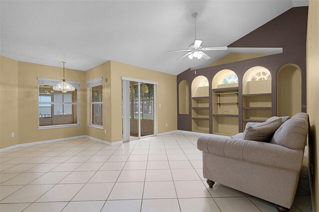 2888 Middleton Cir, Kissimmee, FL 34743 - living area featuring healthy amount of natural light, built in shelves, light tile patterned flooring, ceiling fan, and lofted ceiling