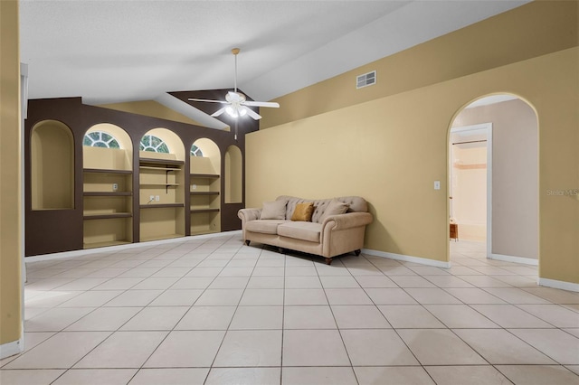 2888 Middleton Cir, Kissimmee, FL 34743 - living area featuring arched walkways, vaulted ceiling, light tile patterned floors, a ceiling fan, and baseboards