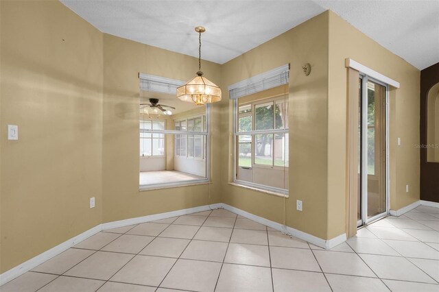 2888 Middleton Cir, Kissimmee, FL 34743 - unfurnished dining area with baseboards, ceiling fan, and tile patterned flooring