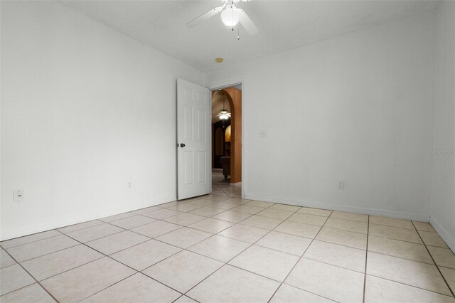 2888 Middleton Cir, Kissimmee, FL 34743 - spare room featuring a ceiling fan, light tile patterned floors, and arched walkways