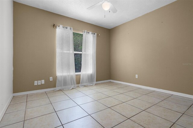 2888 Middleton Cir, Kissimmee, FL 34743 - spare room featuring a ceiling fan, light tile patterned floors, and baseboards