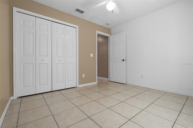 2888 Middleton Cir, Kissimmee, FL 34743 - unfurnished bedroom with a closet, light tile patterned floors, baseboards, and ceiling fan
