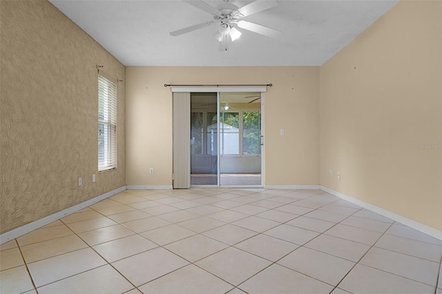 2888 Middleton Cir, Kissimmee, FL 34743 - spare room featuring baseboards, a ceiling fan, and light tile patterned flooring