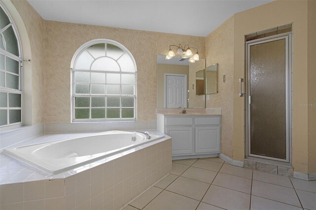 2888 Middleton Cir, Kissimmee, FL 34743 - full bathroom with vanity, a bath, a shower stall, tile patterned floors, and wallpapered walls